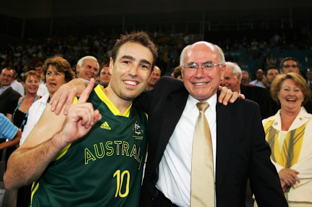 MELBOURNE, AUSTRALIA - MARCH 24:  (L-R) Jason Smith of Australia celebrates with Australian Prime Minister John Howard after the Australian team's victory in the men's gold medal basketball game between Australia and New Zealand at the Melbourne Park Multi Purpose Venue during day nine of the Melbourne 2006 Commonwealth Games March 24, 2006 in Melbourne, Australia.  (Photo by Cameron Spencer/Getty Images)