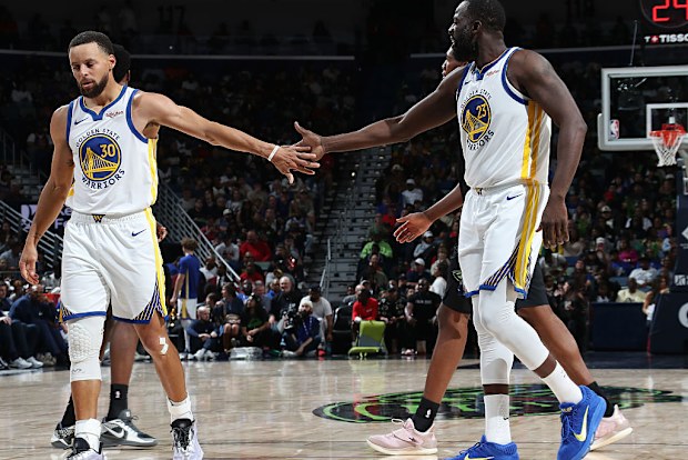 Stephen Curry and Draymond Green high five.