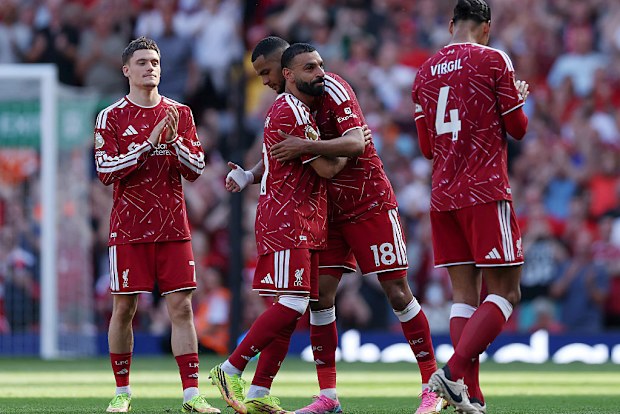 Mohamed Salah of Liverpool embraces teammate Cody Gakpo as he is substituted off.
