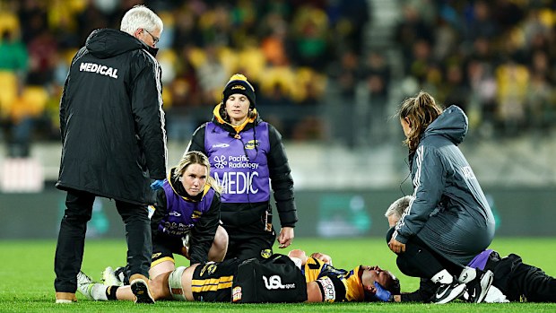 Devan Flanders of the Hurricanes receives medical attention.