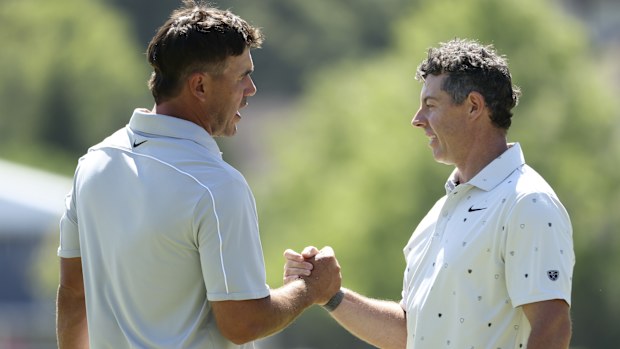 NEWTOWN, PENNSYLVANIA - MAY 16: Brooks Koepka of the United States (L) and Rory McIlroy of Northern Ireland react as they walk off the 18th hole green during the third round of the PGA Championship at Aronimink Golf Club on May 16, 2026 in Newtown, Pennsylvania. (Photo by Jamie Squire/Getty Images)