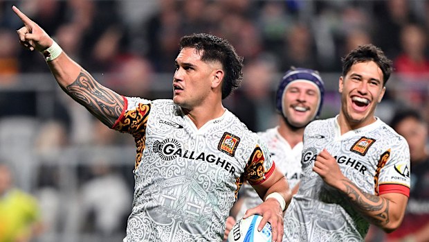 Quinn Tupaea of the Chiefs celebrates scoring a try.