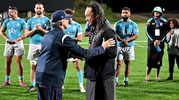 Reds coach Les Kiss and captain Fraser McReight present Australian Aboriginal nulla nulla to Tana Umaga and Miracle Faiilagi.