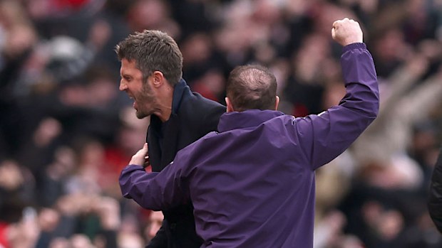 Michael Carrick celebrates with Steve Holland.