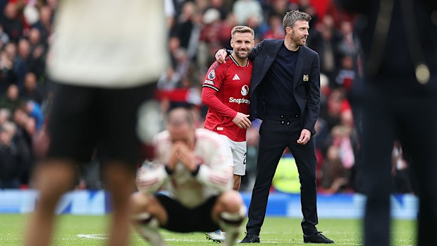 Michael Carrick embraces Luke Shaw of Manchester United following the Premier League match.