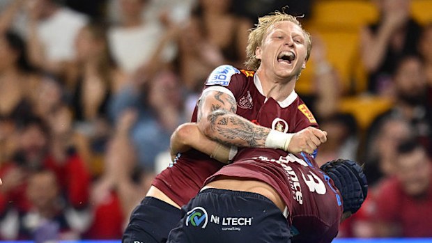 Carter Gordon of the Reds celebrates with team mates after scoring a try during the round nine Super Rugby match.