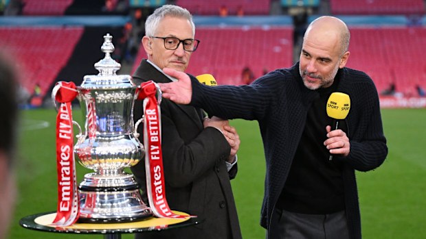 Gary Lineker speaks to Pep Guardiola with the FA Cup trophy.