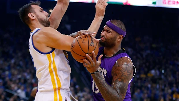 Andrew Bogut and DeMarcus Cousins get into a tussle.