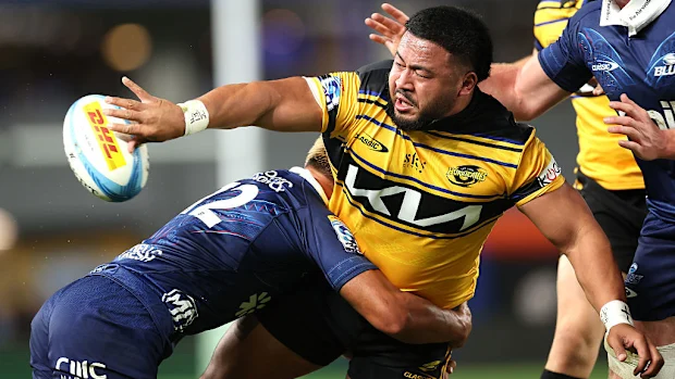 Asafo Aumua of the Hurricanes is tackled.