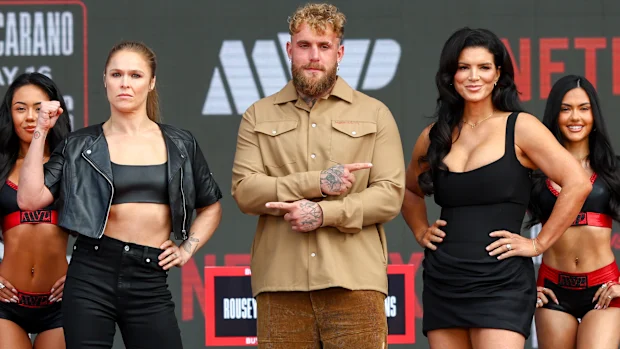 Ronda Rousey, Jake Paul and Gina Carano pose at a press conference.