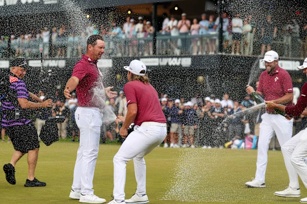 Lucas Herbert of Ripper GC celebrates his win with teammates Cameron Smith and Marc Leishman.