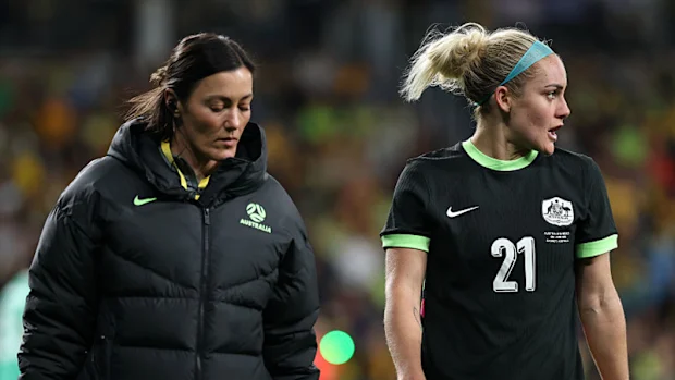 Ellie Carpenter walks with the team doctor.