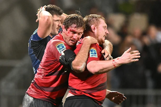 Ethan Blackadder and Fletcher Newell of the Crusaders celebrate.