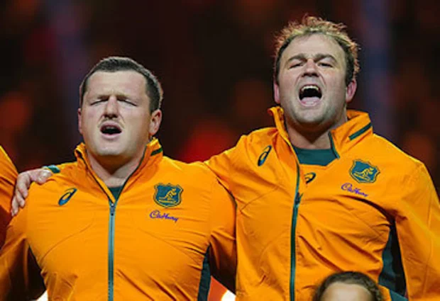 Matt Faessler and Harry Wilson sing national anthem at France v Australia Test match in Paris in 2025 (Franco Arland/Getty)