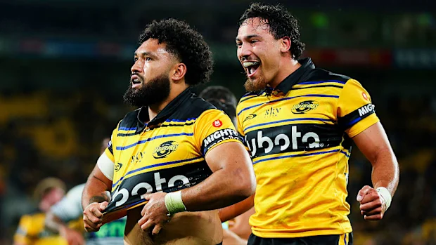 Fehi Fineanganofo of the Hurricanes celebrates with Billy Proctor after scoring a try.