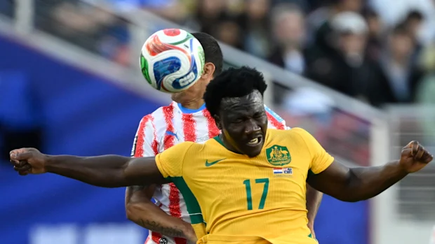 Nestory Irankunda attempts to head the ball towards the net.