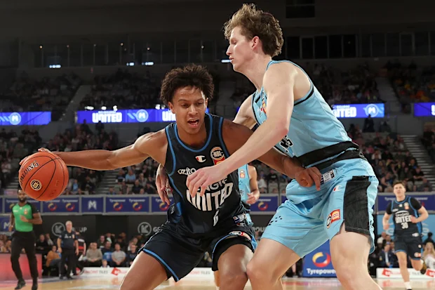 Dash Daniels (left) tries to impose his strength as he handles the ball for Melbourne United during the 2024/25 NBL season.