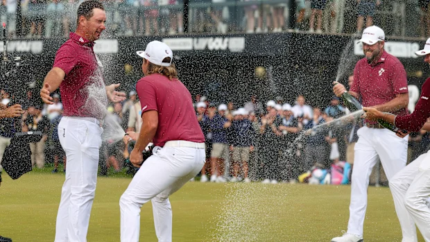 Lucas Herbert of Ripper GC celebrates his win with teammates Cameron Smith and Marc Leishman.
